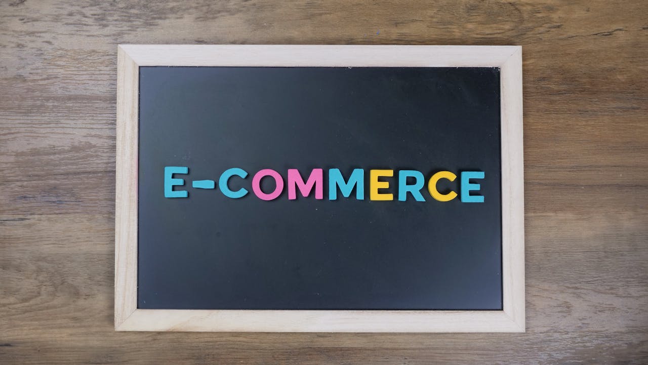 our-story Colorful letters spelling 'e-commerce' on a wooden framed blackboard.